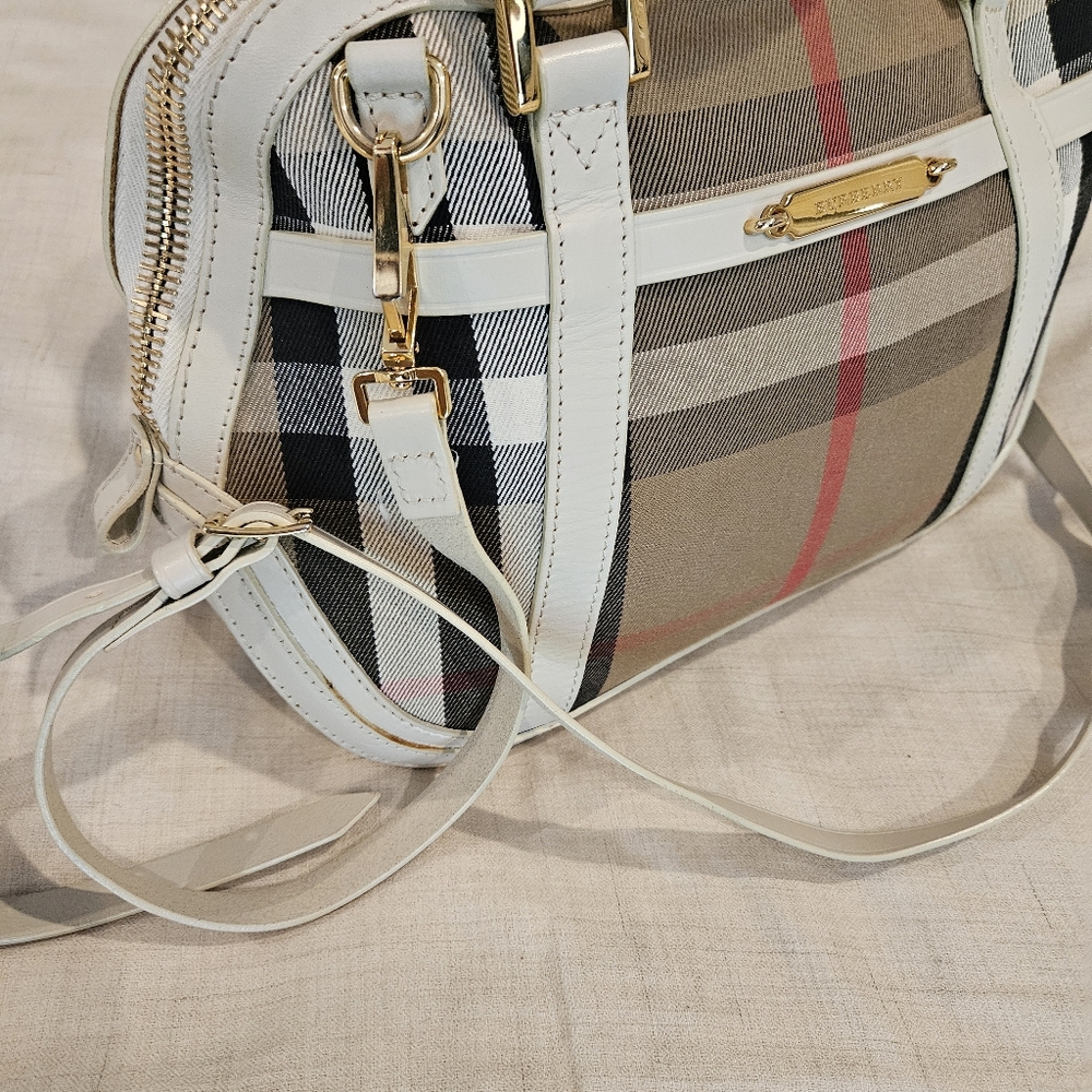 Burberry is a little over-sized crossbody with a top handle bag. Rarely used.